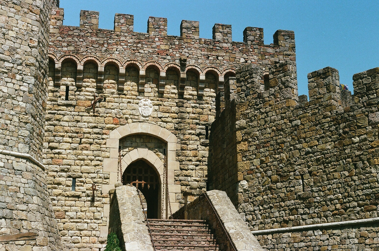 Crenellated stone gatehouse and entry stairs at Castello di Amorosa